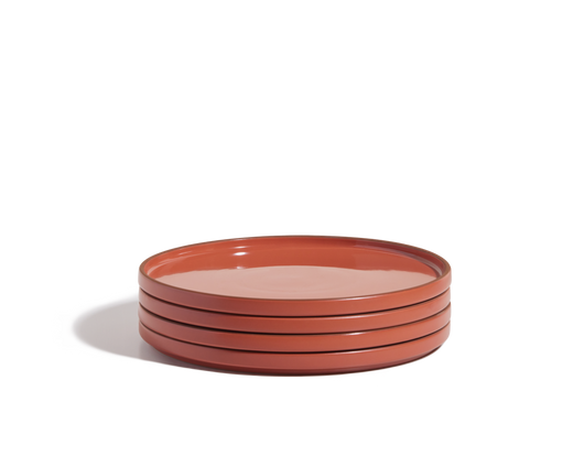 A stack of four round, red hand-glazed Dinner Plates on a white background—perfect for adding a vibrant touch to your tableware collection.