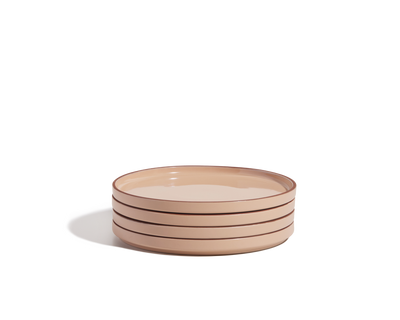 A stack of four beige hand-glazed Salad Plates with brown rims rests on a plain white background, perfect for elevating your tableware collection.