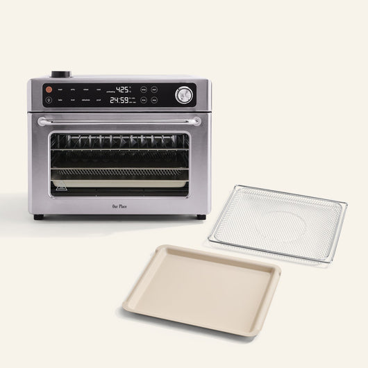 The Wonder Oven Pro + Wonder Oven Pro Essentials Kit, featuring a digital display, is displayed on a white surface with its wire rack and baking tray.