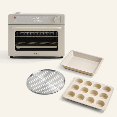 The Wonder Oven Pro + Wonder Oven Pro Chef's Kit is displayed with a baking pan, muffin tray, and perforated tray, all set against a light background.
