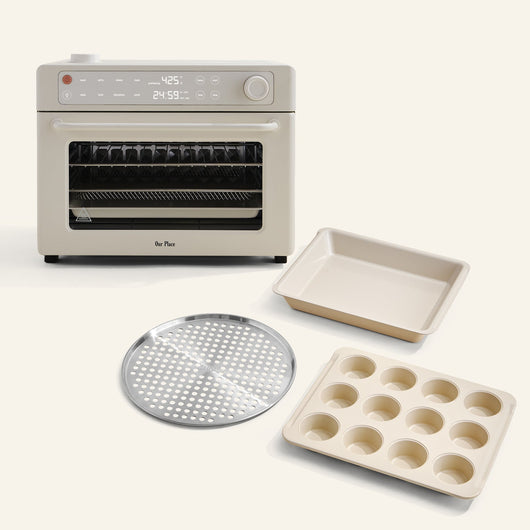 The Wonder Oven Pro + Wonder Oven Pro Chef's Kit is displayed with a baking pan, muffin tray, and perforated tray, all set against a light background.
