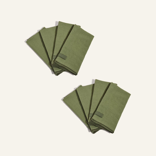 Two sets of four Loop Napkins, neatly folded, are arranged on a plain light background.