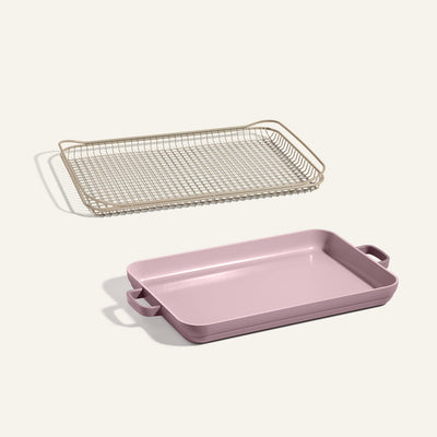 An Oven Rack and a pink Griddle Pan with handles are placed side by side on a light background.