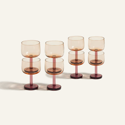 Set of six Party Coupes featuring colorful, amber-tinted bowls and dark red bases. Arranged in two rows on a light background, this vibrant glassware set is perfect for parties and stylish entertaining.