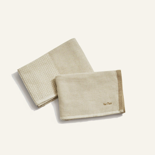 two beige dish towels on white background