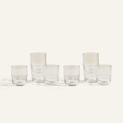 Six clear, empty Short Night + Day Glasses are arranged in two rows on a light background; three are stacked in pairs and three stand alone, highlighting these versatile handmade tumblers perfect for any occasion.