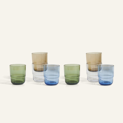 Six Short Night + Day Glasses in green, blue, and light brown are arranged in two rows on a neutral background. Each modern, cylindrical tumbler appears twice, showcasing the unique charm of handmade drinkware.