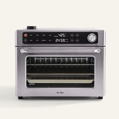 Stainless steel oven with digital display on a white background