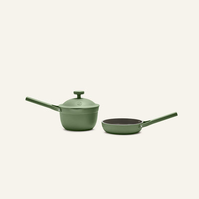 The Tiny Cookware Duo, featuring a green saucepan with lid and a matching green frying pan, is displayed side by side on a light background.