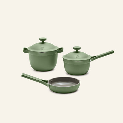 The Tiny Cookware Duo + Petite Perfect Pot set features three green nonstick pieces—a deep pot, saucepan, and frying pan—each displayed on a neutral background with matching handles and lids.