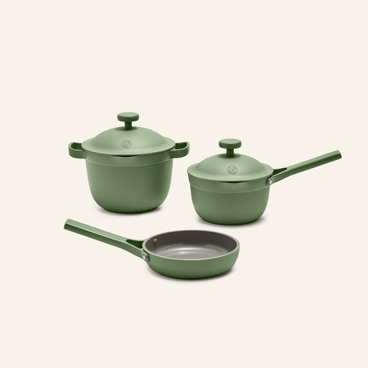 The Tiny Cookware Duo + Petite Perfect Pot set features three green nonstick pieces—a deep pot, saucepan, and frying pan—each displayed on a neutral background with matching handles and lids.