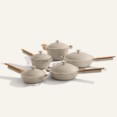 Set of beige cookware with wooden handles on a white background