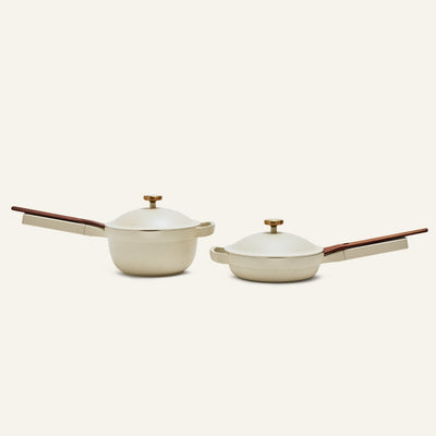 The Mini Cookware Duo includes a beige nonstick deep saucepan and shallow skillet with matching lids and wooden handles, shown side by side. These bestsellers are perfect for versatile, everyday cooking.